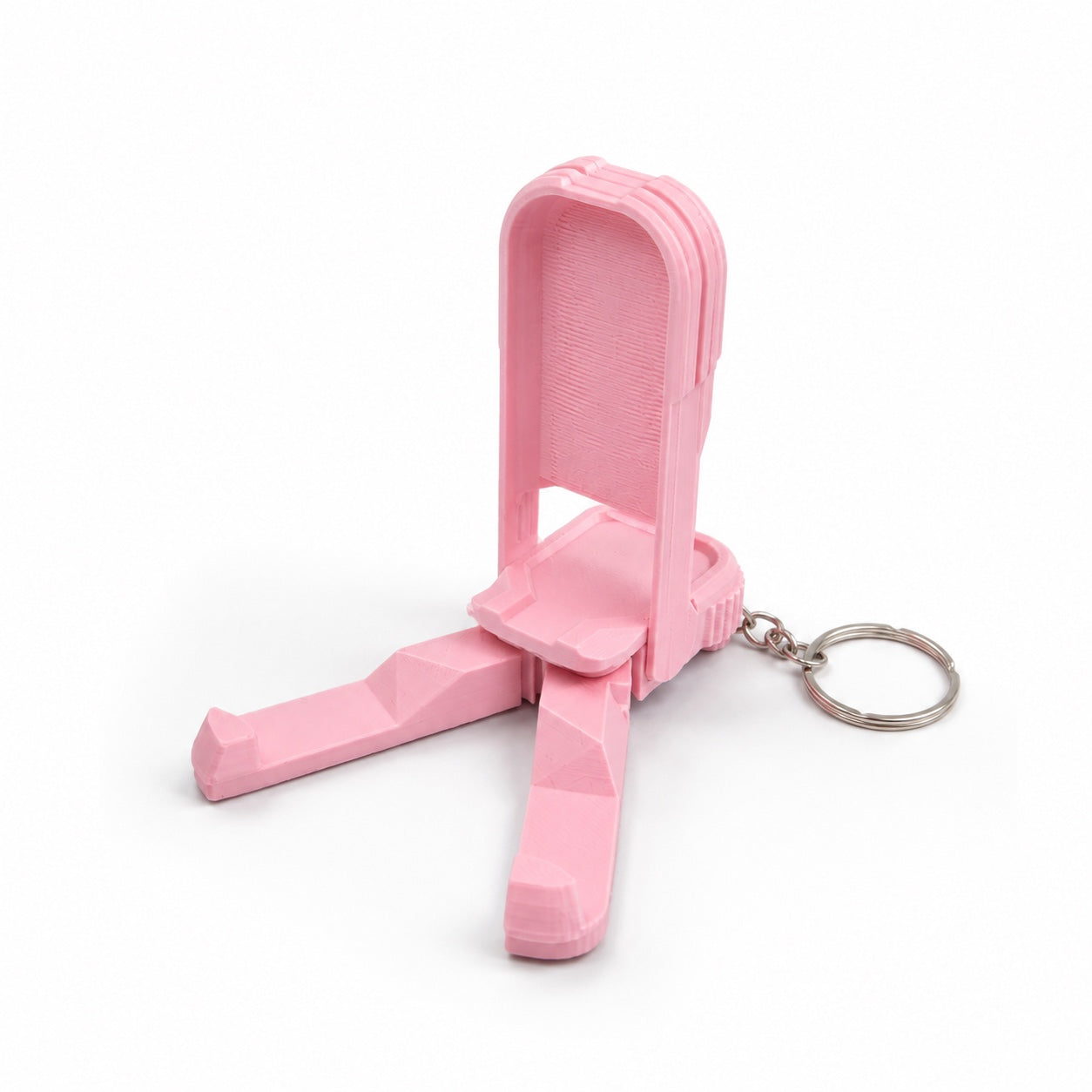 Pink fidget phone stand keychain opened as a compact tripod phone holder